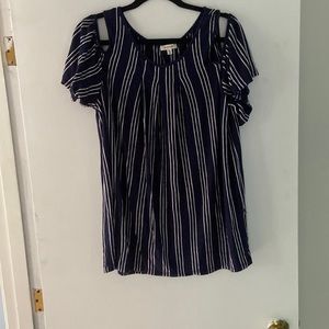 Blue, off the shoulder flowy shirt.